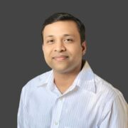 A man in a white shirt is posing for a photo, possibly for marketing purposes.