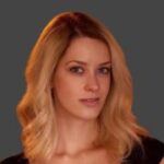 A blond woman in a black top posing for a marketing photo.