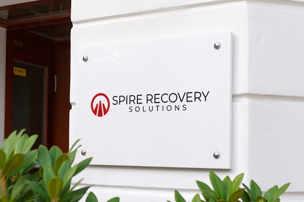 A reputable collection agency, Spire Recovery Solutions, proudly displays their sign outside a building.