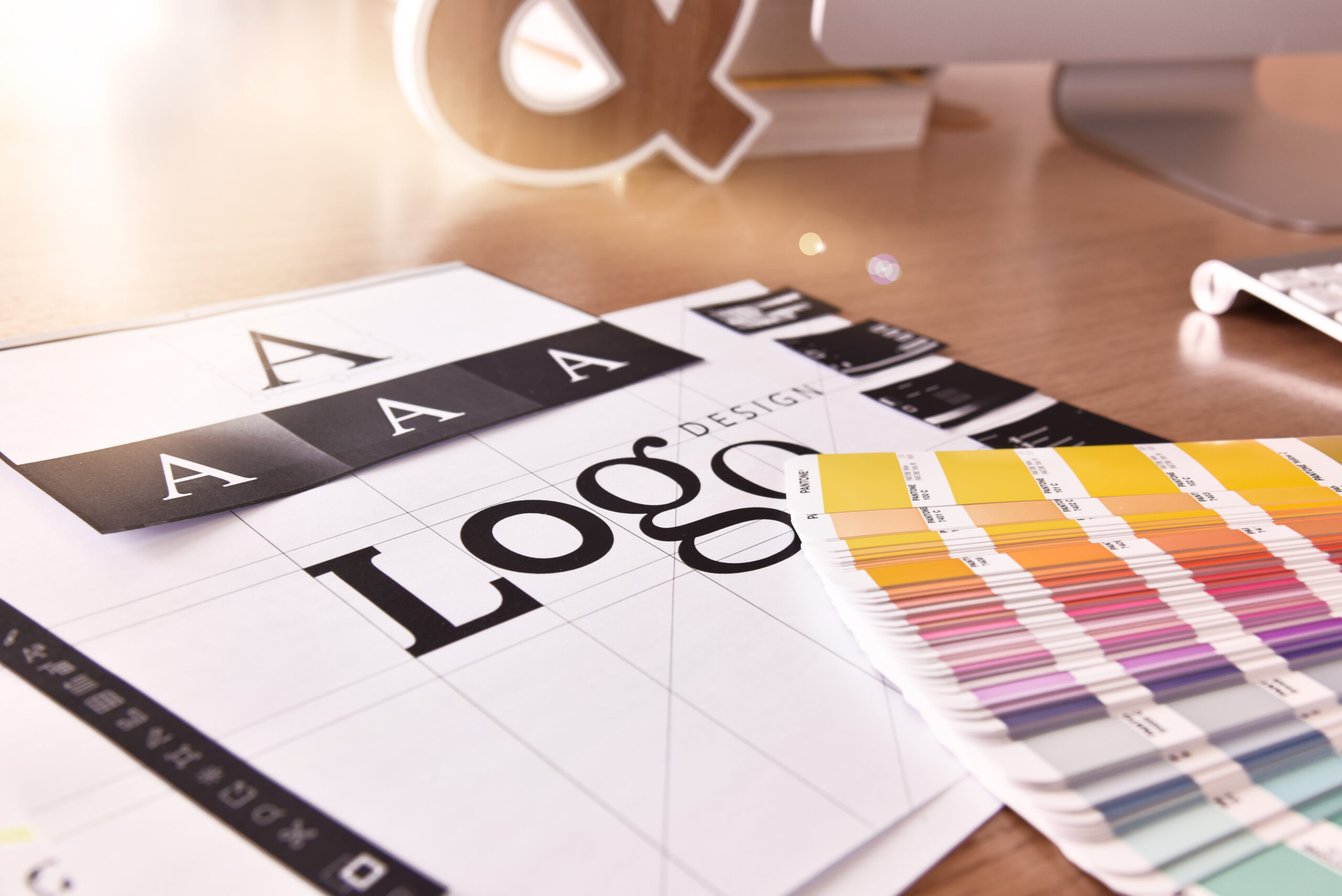 A desk with a logo and color swatches used for marketing purposes.