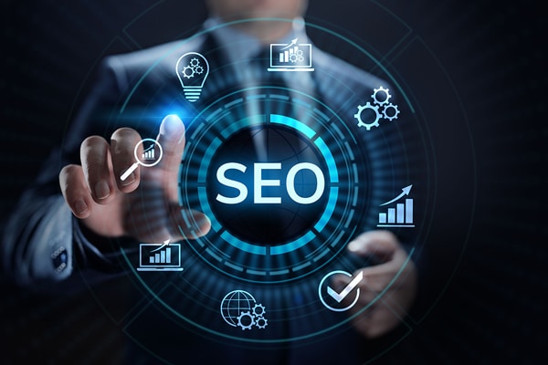 A man in a suit is pointing at an SEO icon related to marketing.