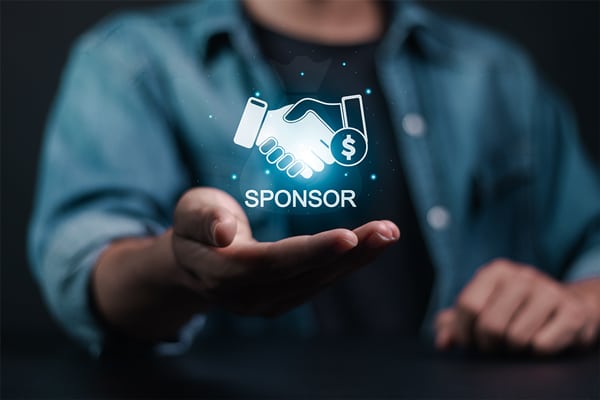 A person holding out their hand with a holographic image of a handshake, money symbol, and the word "SPONSOR" hovering above the palm.