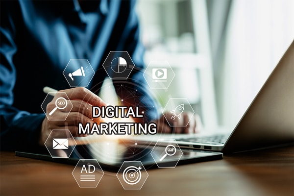 Digital marketing concept with a person using a laptop and hexagonal icons representing various digital marketing elements.